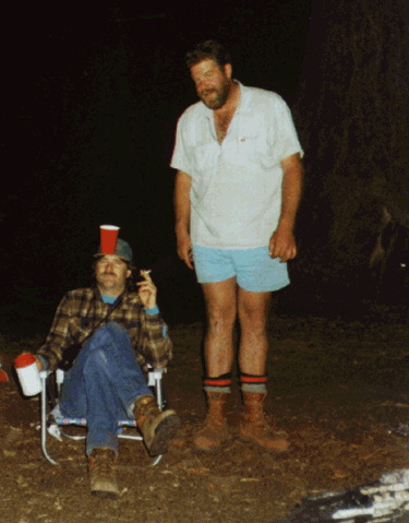 Two men at camp at night