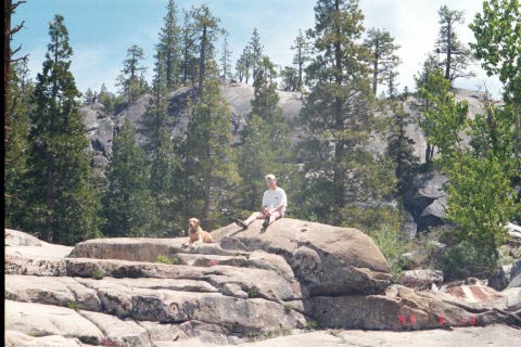 Person and dog on granite rocks at the Kegger