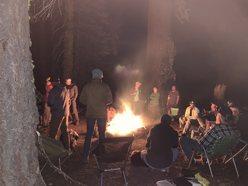 The Kegger camp around the fire at night, 2021