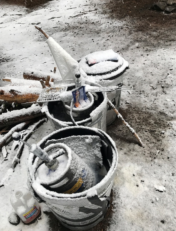Two kegs covered in snow at the 2025 Kegger